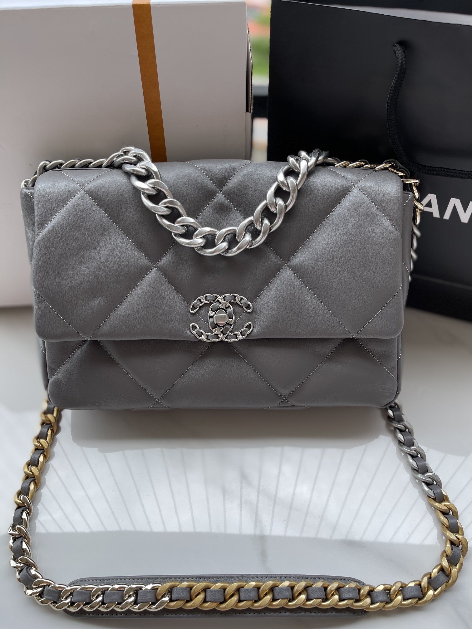 Ch*el 19 large handbag shiny leather, gold-tone, silver-tone & ruthenium-finish metal gray 7.8 × 11.7 × 3.9 in