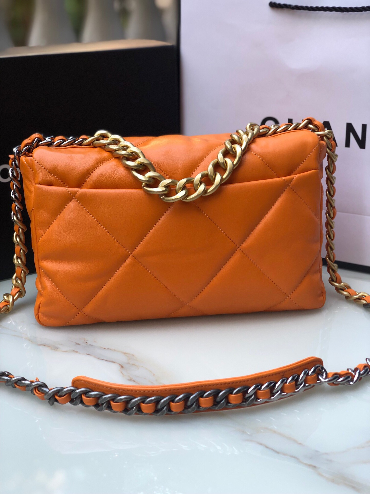 Ch*el 19 large handbag shiny leather, gold-tone, silver-tone & ruthenium-finish metal orange 7.8 × 11.7 × 3.9 in