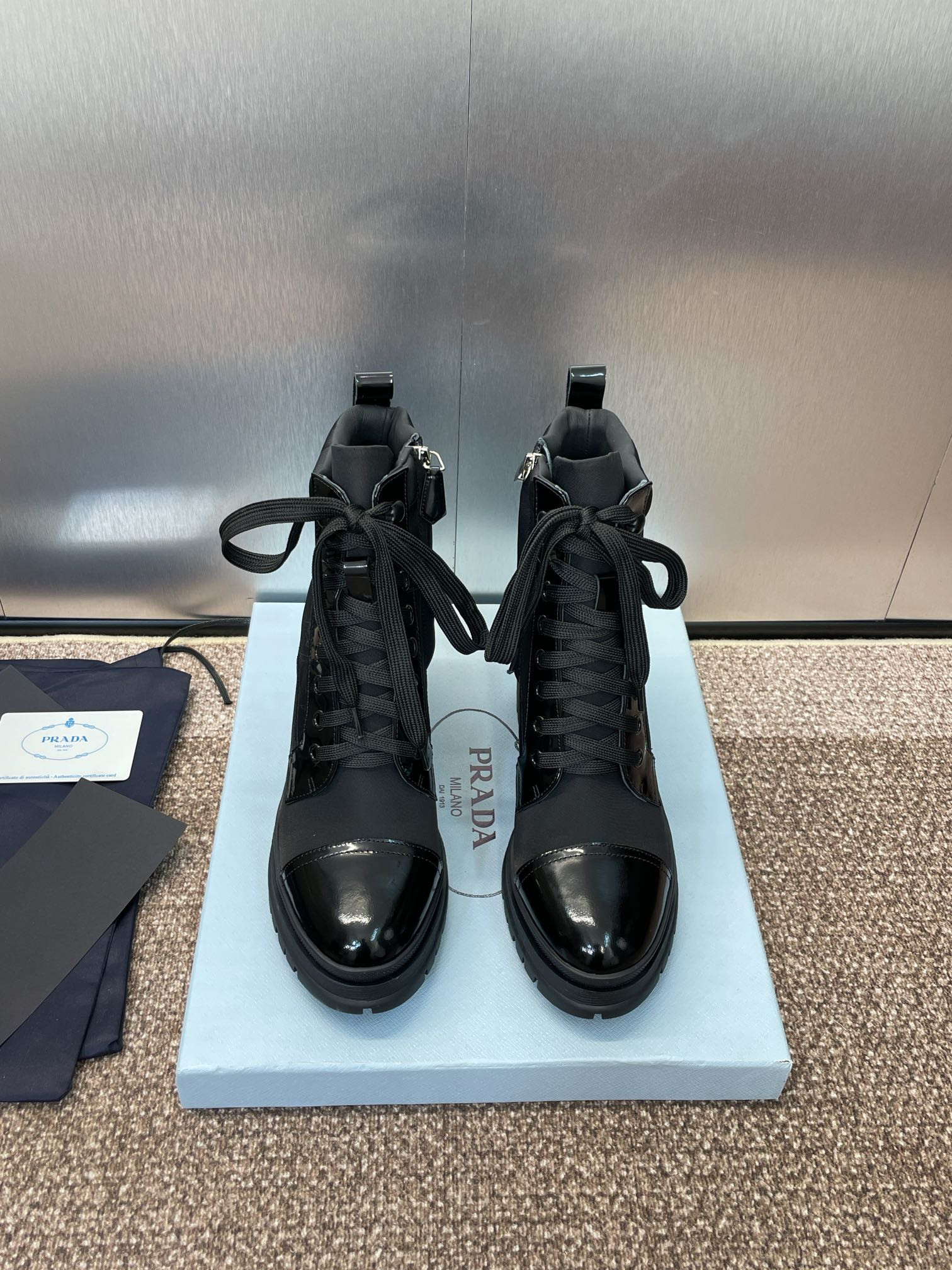 ua Pra*a re-nylon and leather booties