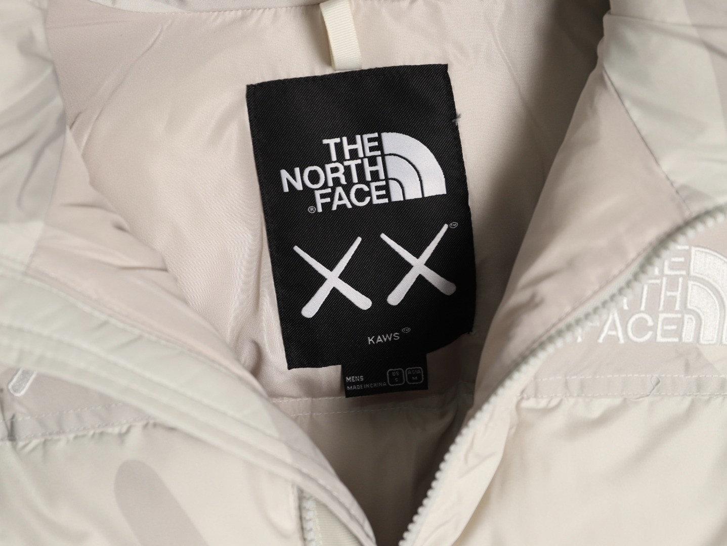 the n0r*h Fa*e x kaws short puffer jacket